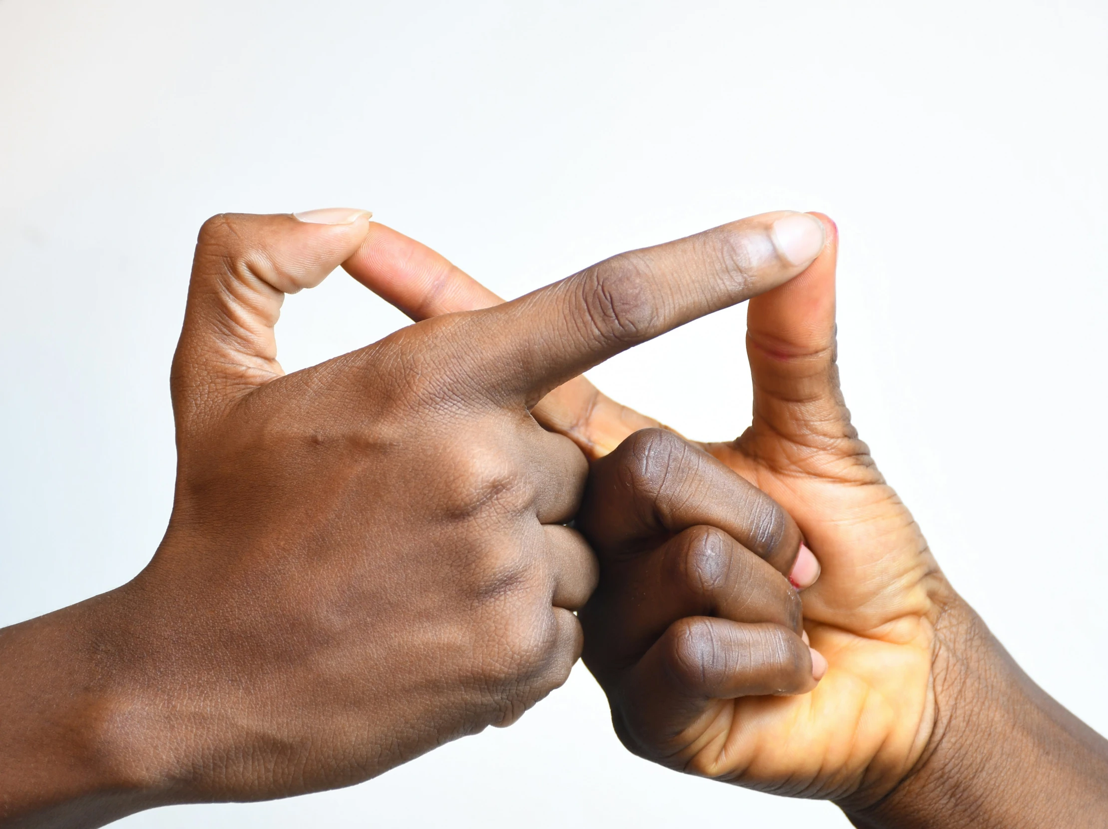 a couple of hands making the letter m with their fingers