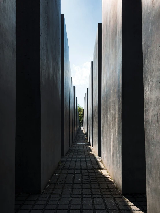 a narrow alley lined with concrete walls