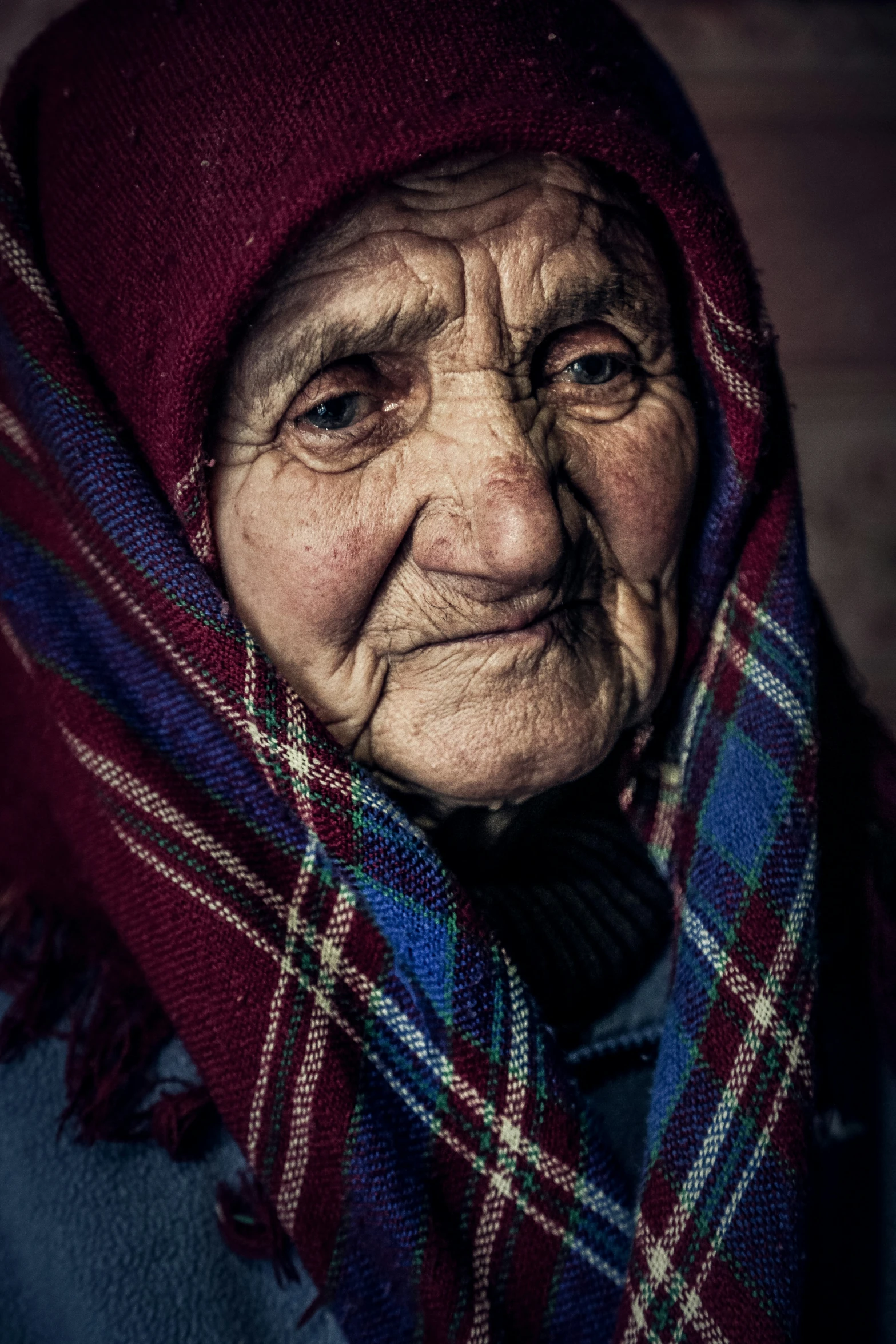 a woman wearing a blanket looking off to the right