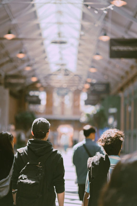 several people walk along a busy, walkway in the city