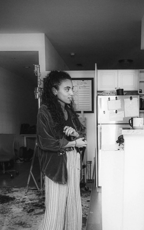 an individual standing in the kitchen of their home