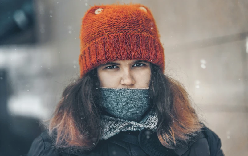 the girl is looking sad as she covers her mouth with her hands