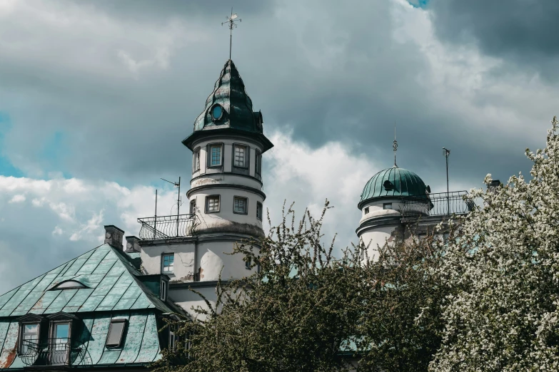 a large building with two towers and trees