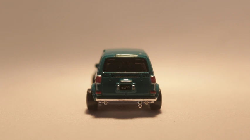 a toy truck is sitting on a white surface