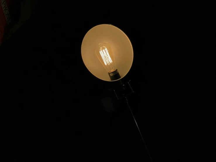 an antique streetlight in the dark during the day