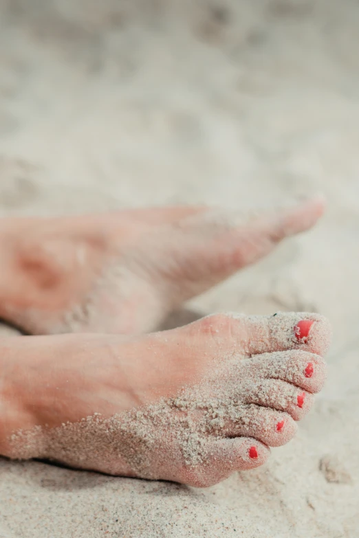 the sand beneath the person has red spots