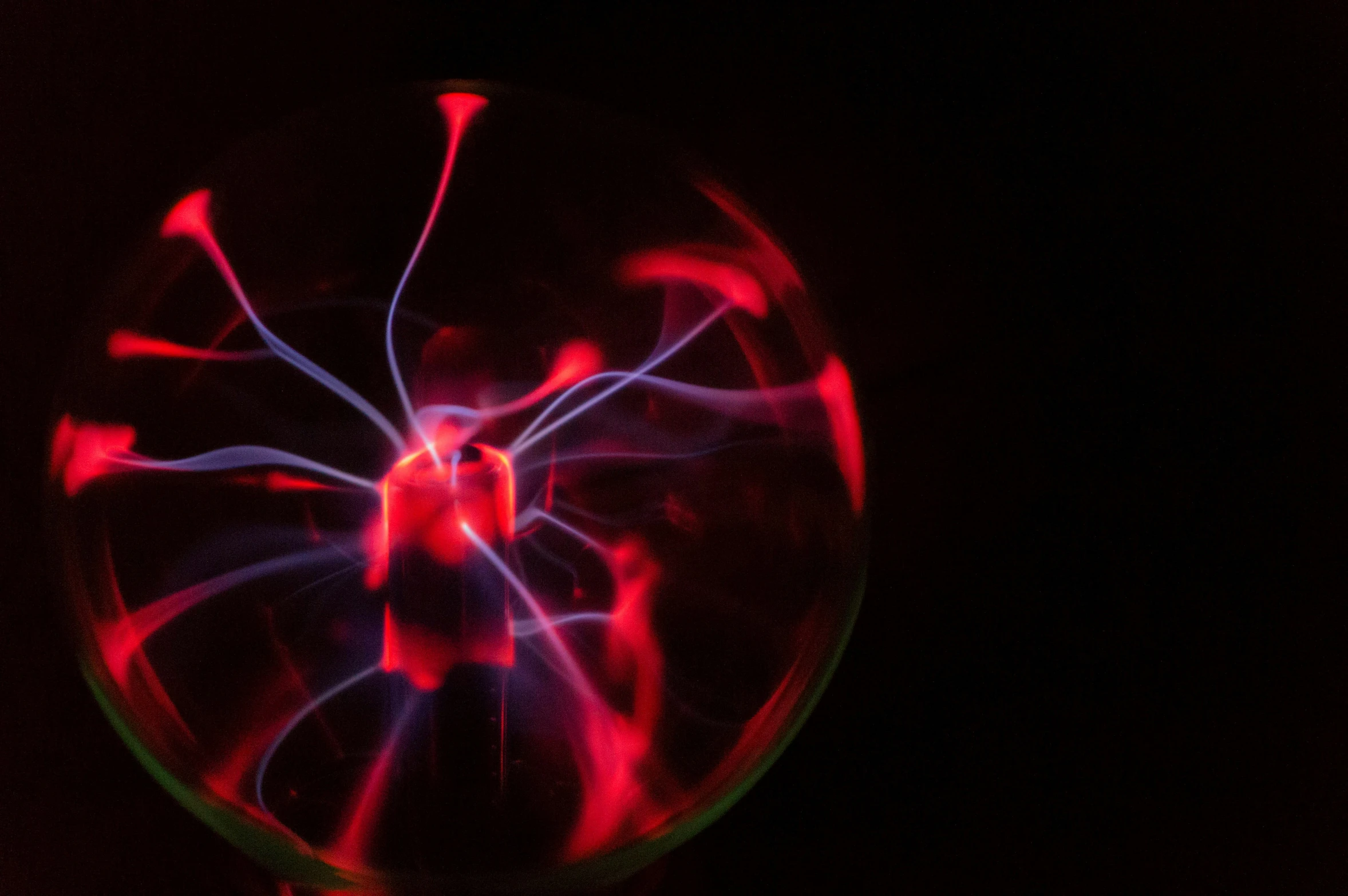 a spinning disc in the dark with red lines