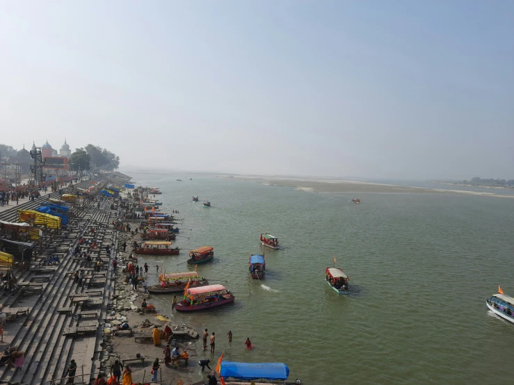 some boats are docked next to the shore