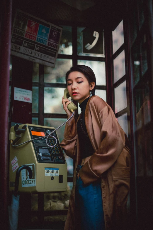 a woman standing outside talking on her cell phone