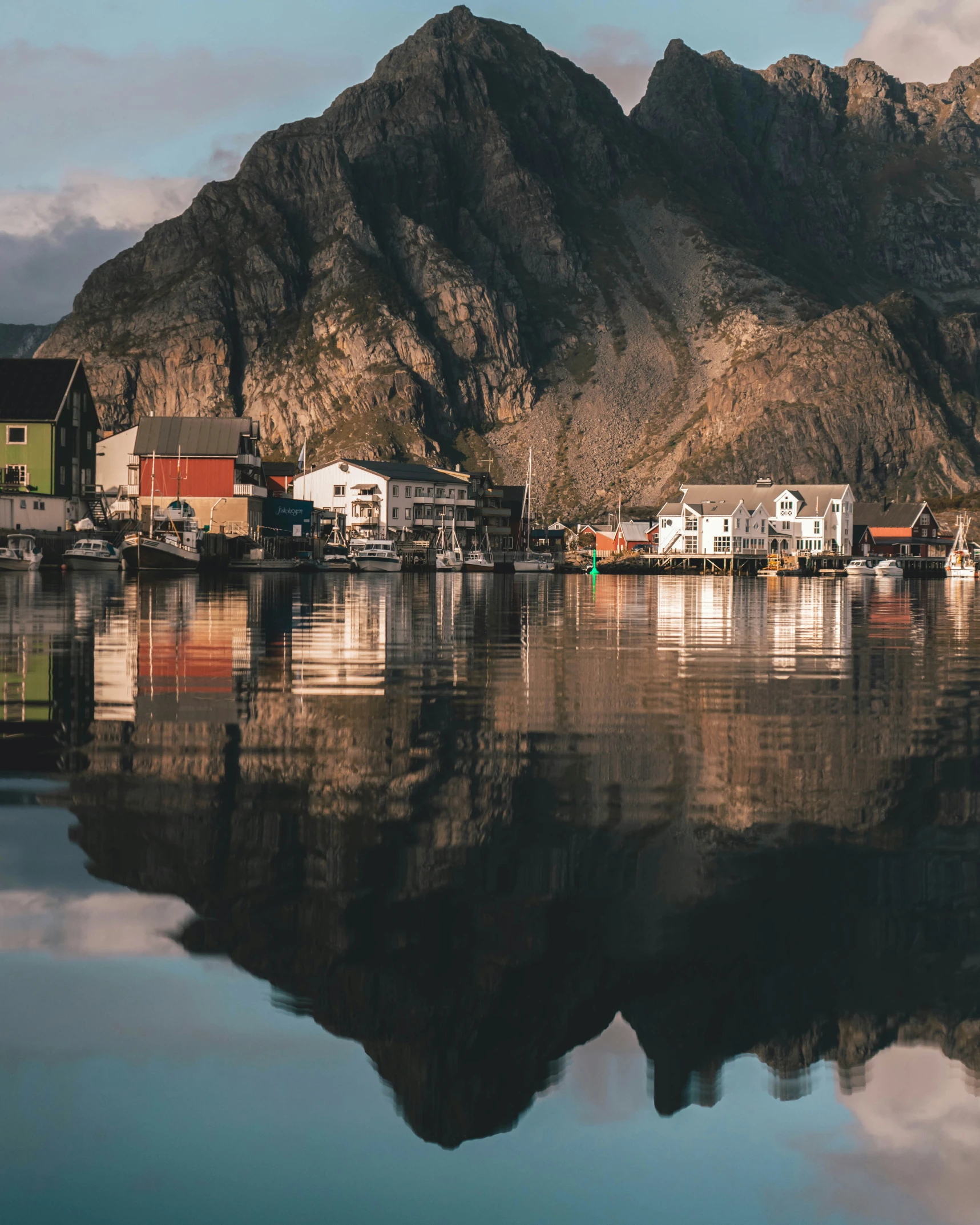 the small village is situated in front of a huge mountain