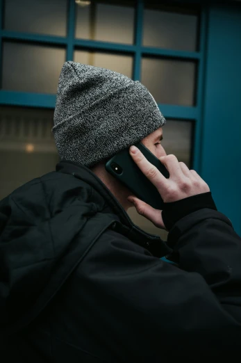 a person on the phone wearing a winter hat