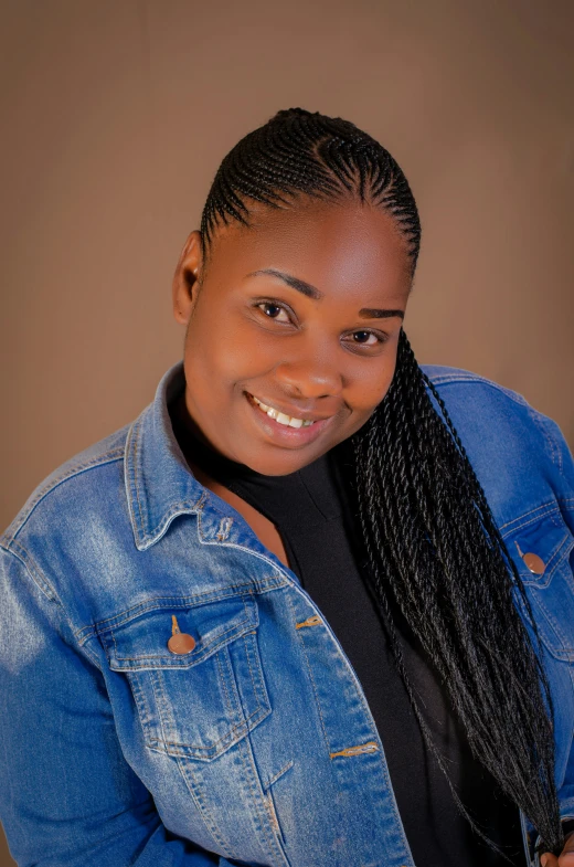 a woman smiling in a denim jacket and ids