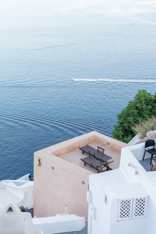 the sky is clear and there are many chairs near the water