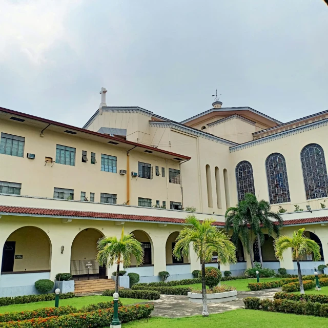 a building with several courtyards, plants and trees on the front and top