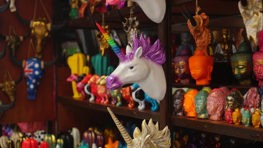 many colorful toy items are hanging from shelves