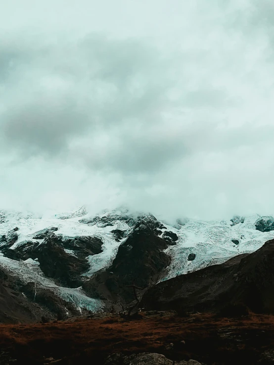 the snow covered mountains are all covered in small white patches