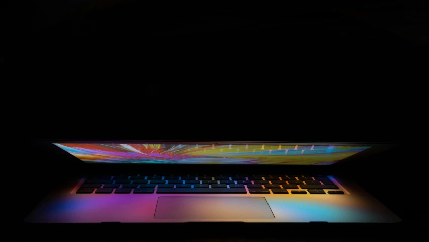 the laptop is lit up in bright colors