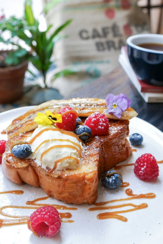 a piece of french toast with fruit and whipped cream on a plate