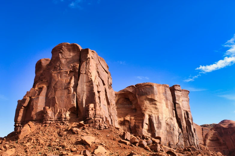 a lone horse riding among some large rocks