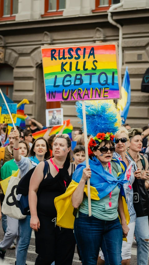 two women with signs in the street at a rally