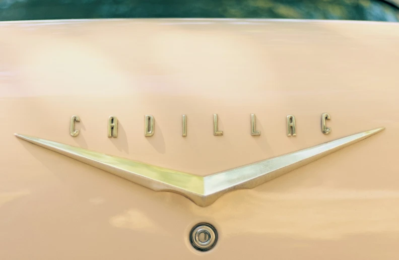 there is a sign that says, cadillac on the car's hood