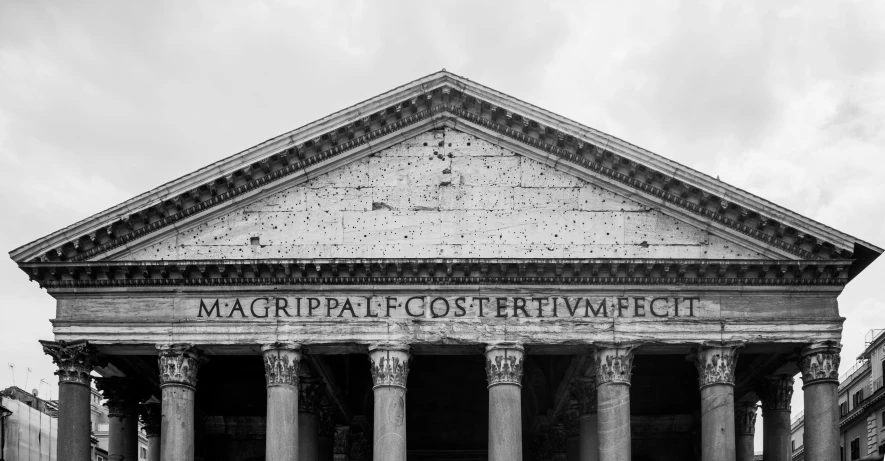 an ancient architectural building with columns and lettering