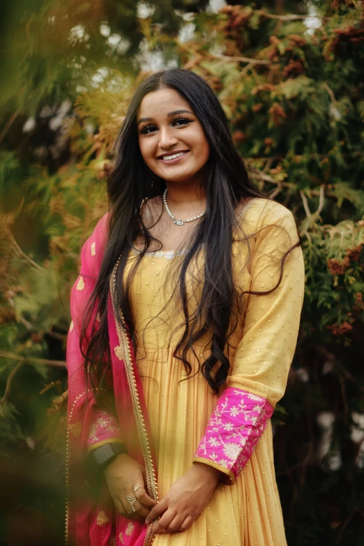 a woman in an indian outfit, smiling
