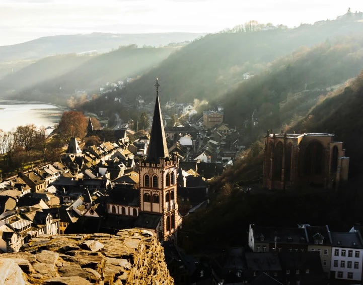 a tall church tower towering over a valley