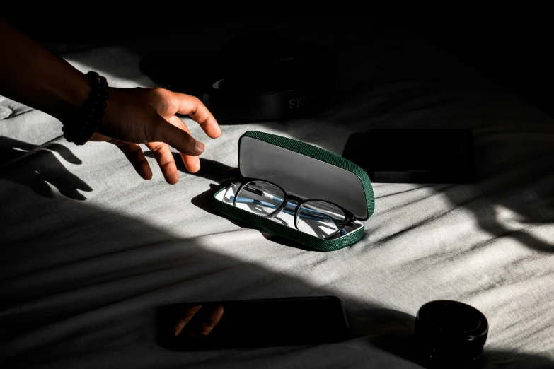 an opened box is shown with glasses on it
