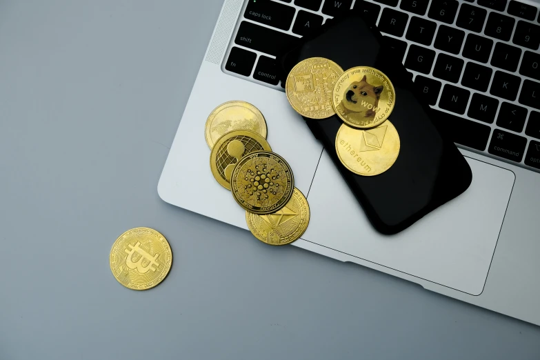 the gold coins are scattered next to the keyboard