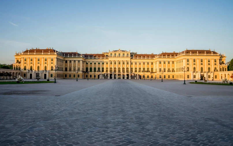 an exterior view of a palace with a parking lot