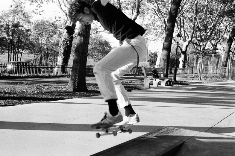 the young person is jumping on a skateboard