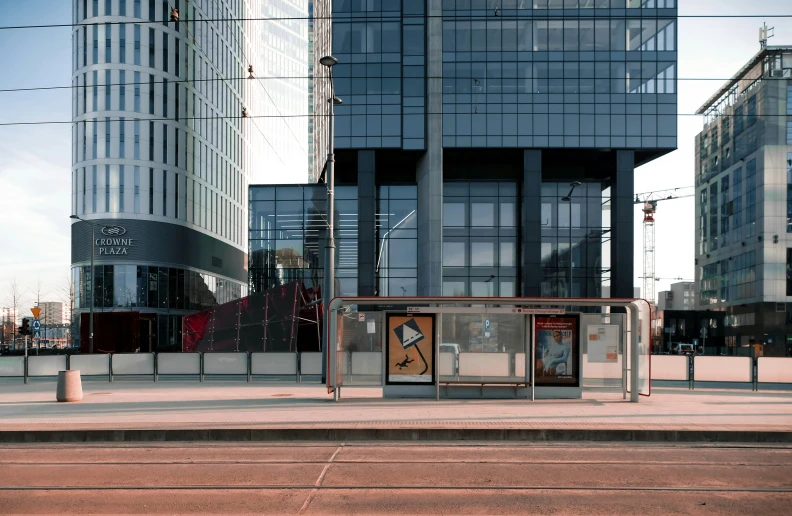 a bus stop is shown near the buildings