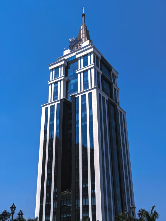 a tall building is seen against the blue sky