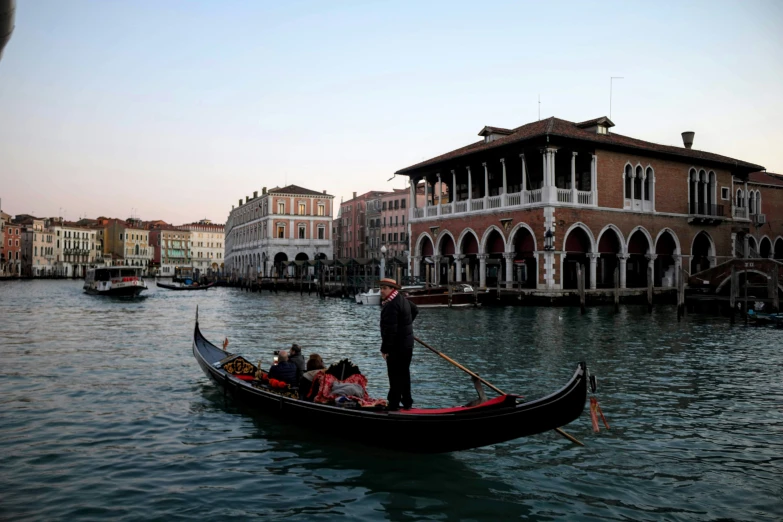 a man standing on top of a boat in the water