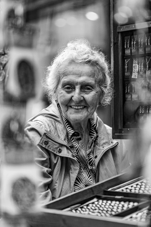 an elderly woman sits in front of a computer