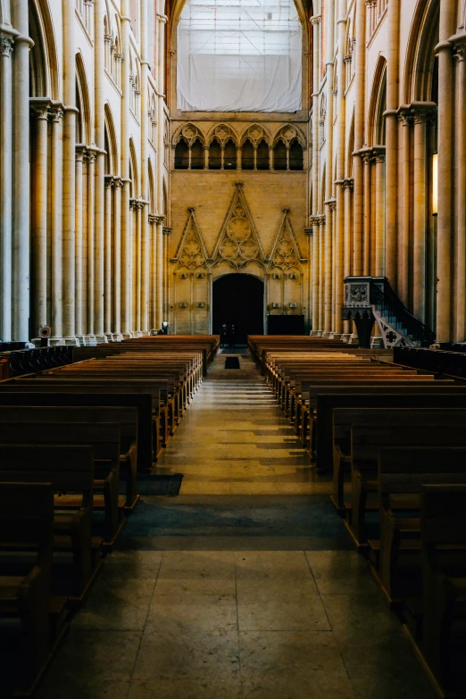 a row of pews sitting in the middle of a cathedral