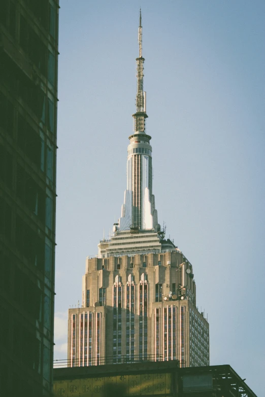 the top of a tall building against a blue sky