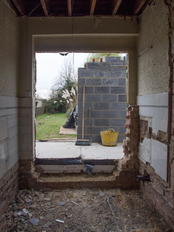 an empty garage with construction materials outside