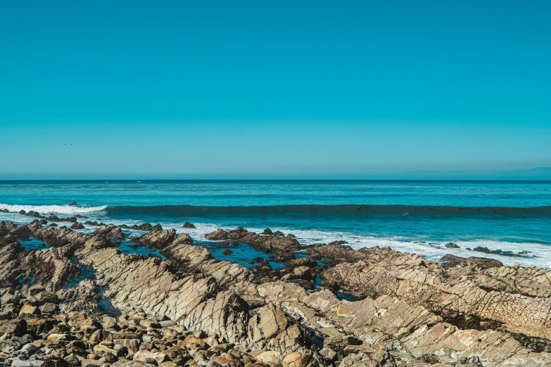 a po of the sea with some water and rocks