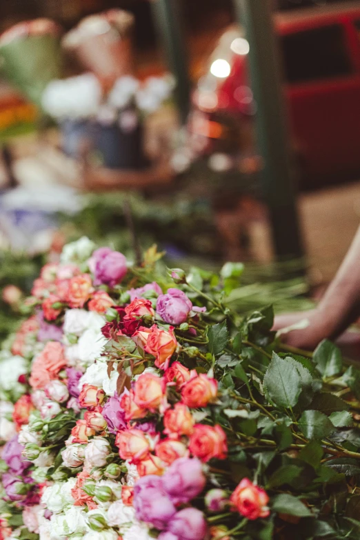 pink and white flowers are set in a basket