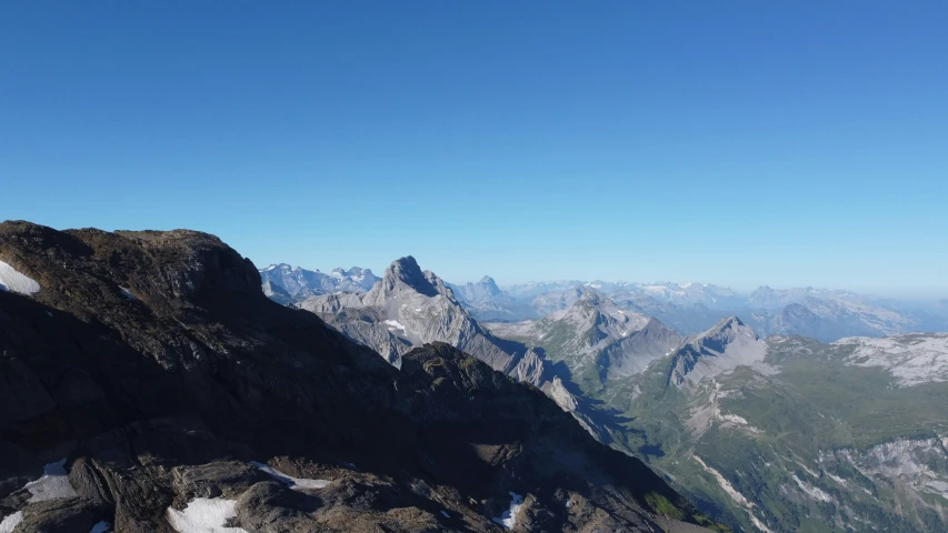 an extreme view of a mountain range and the summit of a mountain