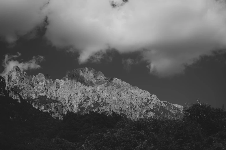 a black and white image of clouds and mountains