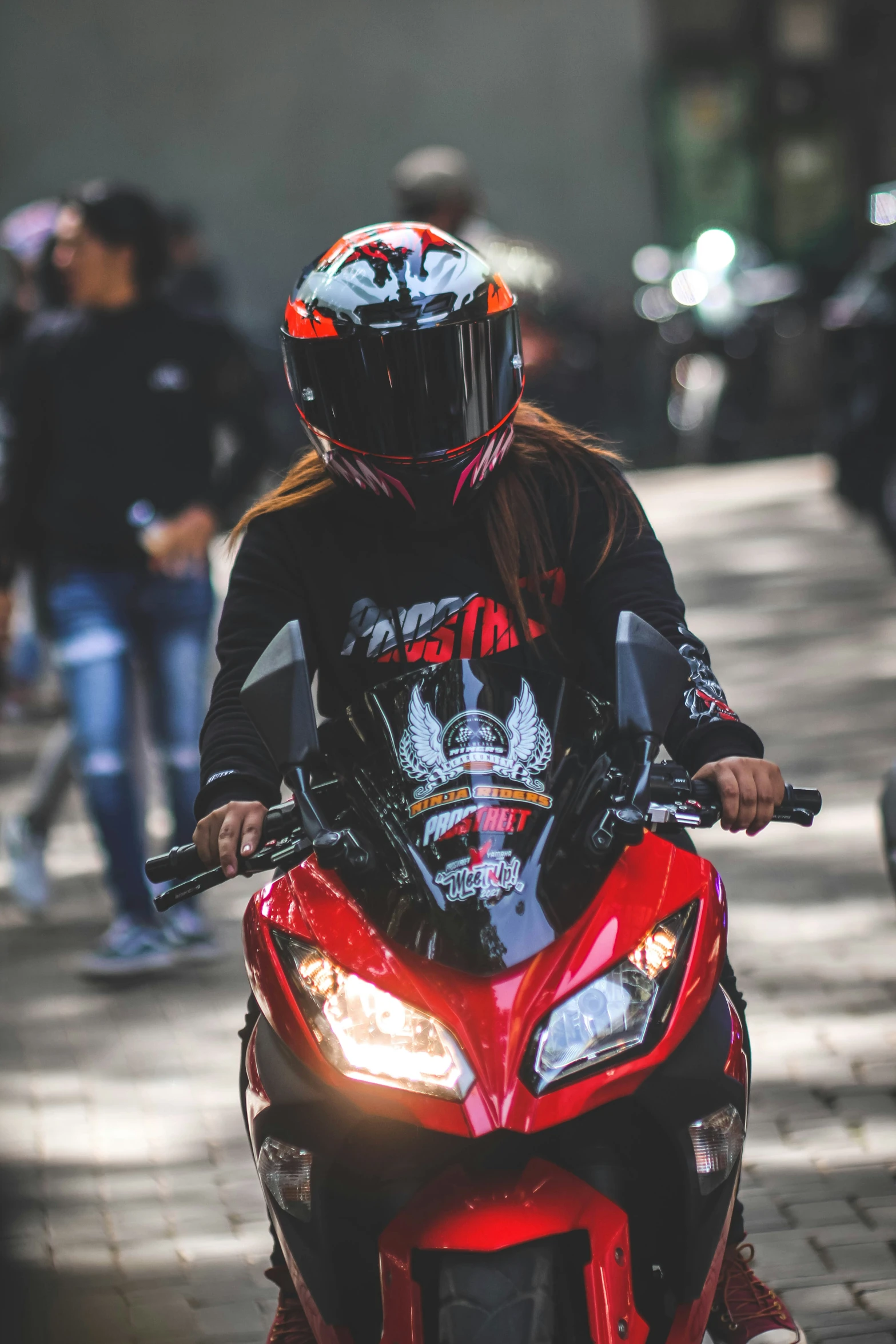 a person riding on the back of a red motorcycle