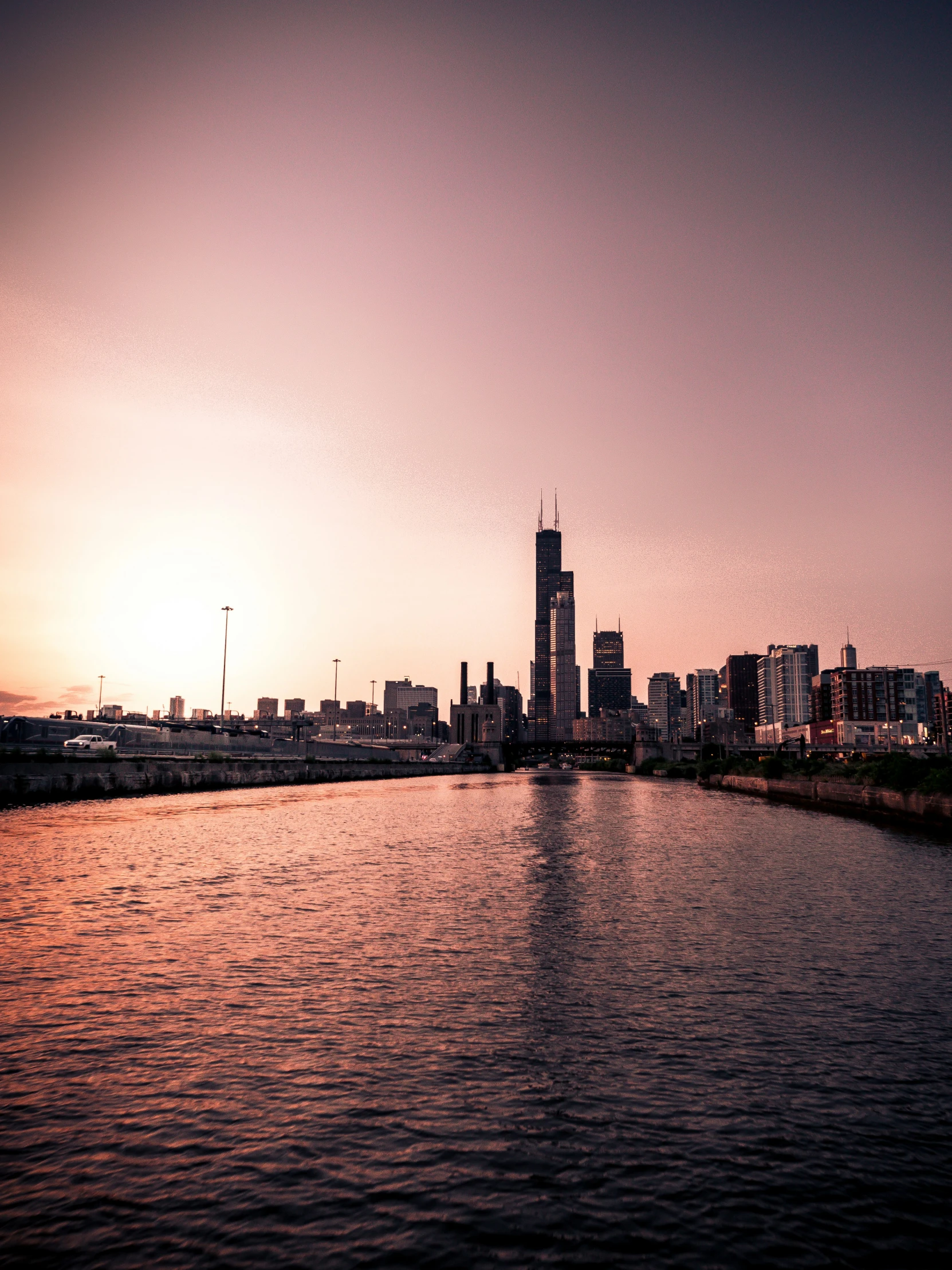 the skyline is seen in the distance of this river