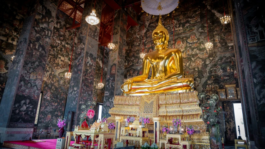 golden statue sitting on a platform inside of a church