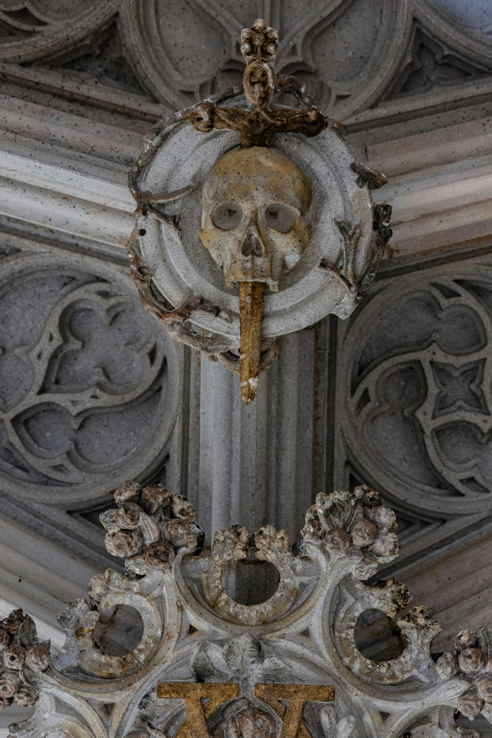 a gold and white clock hangs from a tall building