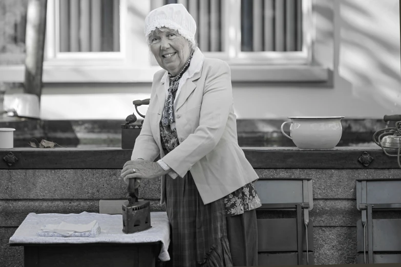 a woman standing at a counter cooking food