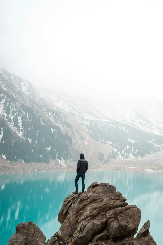 a man is looking out over the blue water