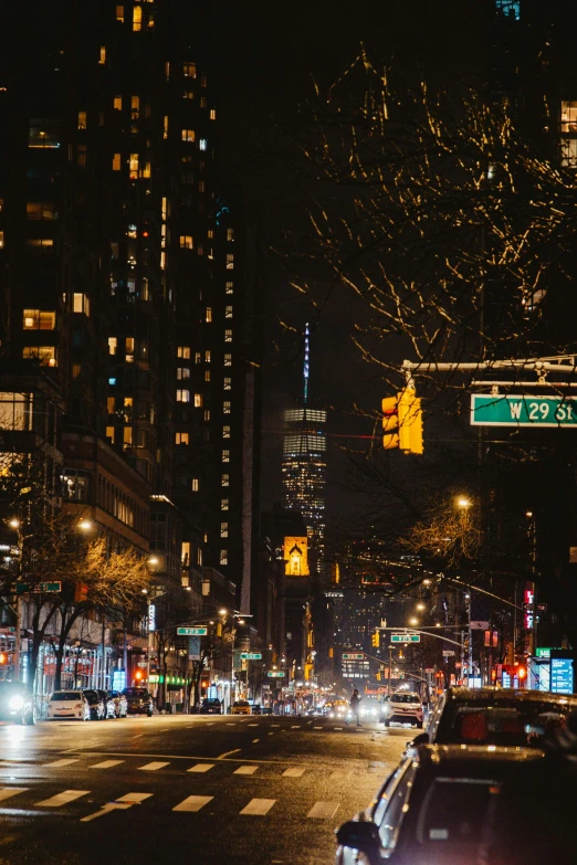 cars traveling down the city street at night